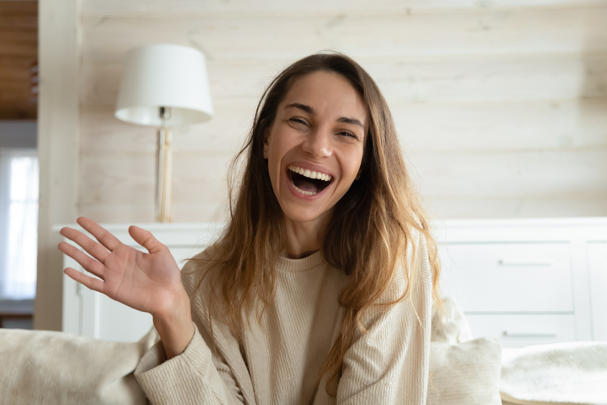 Smiling Woman Waving Hand